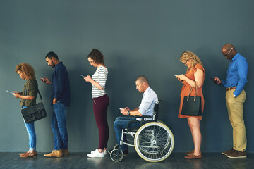 Human resources, inclusive and job interview with row of people in studio on gray background for opportunity. Diversity, hiring or recruitment and man with disability in wheelchair for equality