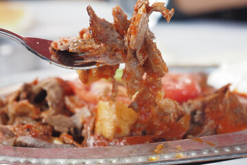 A Savory and Flavorful Plate Featuring Tender Meat Accompanied by Fresh Vegetables and Sauce