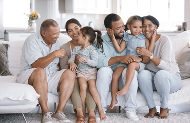 Mother, father and grandparents with kids on couch, bonding together and happiness in lounge. Apartment, generations and big family on sofa, care and love with break, playful and joyful with smile