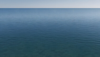 Obraz premium A serene view of calm water with gentle ripples, reflecting a soft blue hue. The surface appears smooth and tranquil, creating a peaceful atmosphere.