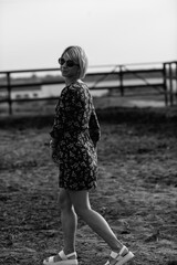 Portrait of a young beautiful girl on a horse farm. Black and white photo.