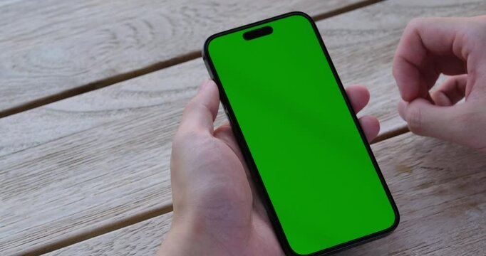 hand swipe green screen phone close up