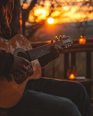 silhouette of a person playing guitar with sunset background