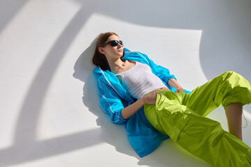 Fashion portrait of young woman in sport jacket and pants.