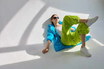 Fashion portrait of young woman in sport jacket and pants.