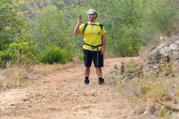 Lost hiker using a phone outdoors. 
