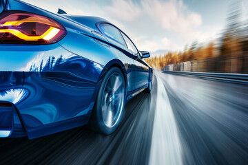 Fototapeta premium A blue car is speeding down a road