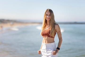 Young woman posing on a beach on a sunny day