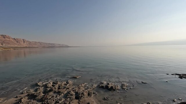 Experience the untouched beauty of the Dead Sea's northern shores at Matzuki Darga in the soft light of early morning. This serene and wild beach showcases the unique landscape of Israel's Dead Sea