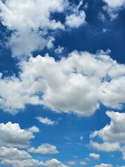  A vibrant blue sky filled with fluffy white clouds.