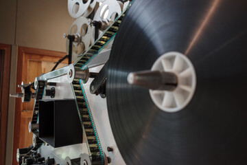 A detailed close-up view of a vintage film projector’s mechanical components, showcasing gears,...