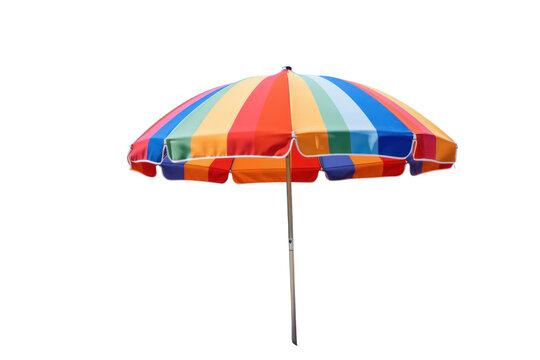 A colorful beach umbrella with vibrant stripes set up on a sandy beach with a clear blue sky in the background