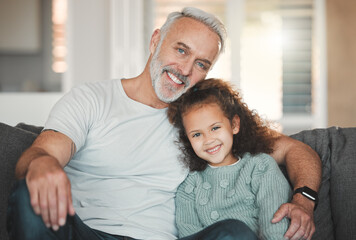 Obraz premium Portrait, home and grandpa with girl on sofa, love and hug with comfort, support and weekend break. Face, family and relax on couch, grandfather and daughter with smile, happiness or bonding together