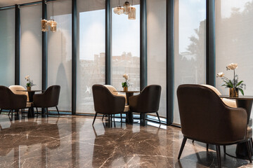chairs and table near glass wall