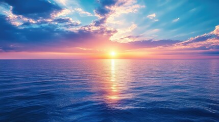 Obraz premium A stunning blue sunset over a calm ocean, with the sky and water blending seamlessly