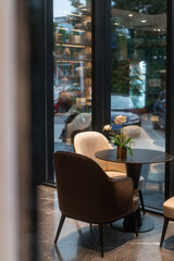 chairs and table near glass wall