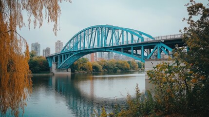 Obraz premium A wide shot of a blue bridge spanning across a river, connecting two urban areas