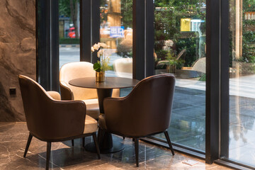 chairs and table near glass wall