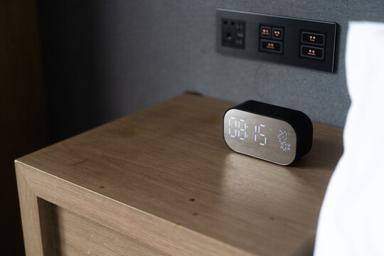 clock with digital display on side table 