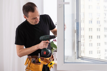 Fototapeta premium Young worker checking window after repair