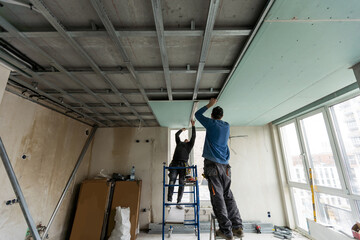 Construction worker installation ceiling work