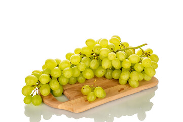 Bunch of sweet grapes on wooden kitchen board, macro, isolated on white background.