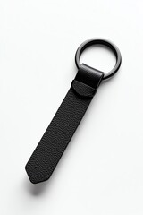 A mockup of a black leather keychain with a minimalist metal charm, on a plain white background, in a high-end, luxurious style