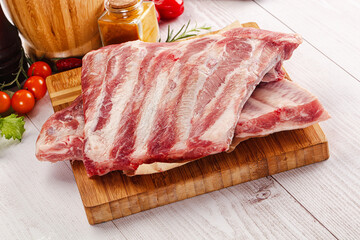 Raw pork ribs over board
