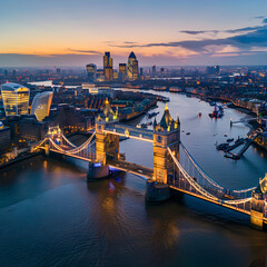 Fototapeta premium Aerial view of the illuminated tower bridge and skyline of london, uk, at sunset
