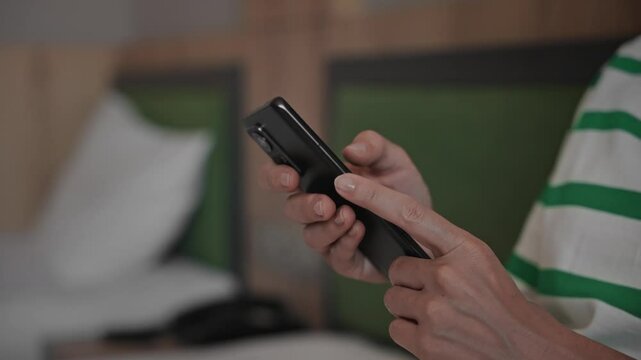 Close-up. An unrecognizable woman uses a smartphone. Hands and phone in the frame, internet technology and wi-fi.