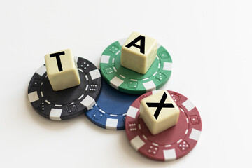 Tax or vat word on wooden cube on white board background. Business financial concept.