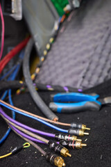 Closeup image featuring hands fixing electrical wires in a car for maintenance and repair