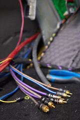 Closeup image featuring hands fixing electrical wires in a car for maintenance and repair