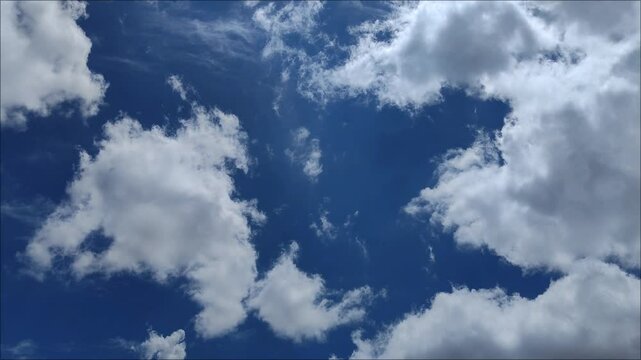 Radiant sky with cirrus clouds leaving and cumulus clouds comingRadiant sky with cirrus clouds leaving and cumulus clouds coming