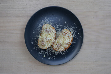 Toasted bread with cheese on top.