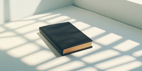 A Hardcover Book With A Black Cover On A White Tabletop