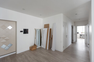 bright interior design of a room with a large window and wooden floor