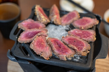 Set of Gyukatsu or beef cutlet on the frying pan. A traditional Japanese food that consists of a deep-fried beef cutlet.