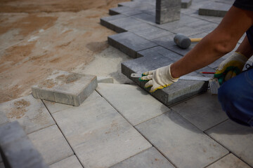 The Comprehensive Process for Installing Paving Stones Utilizing a Hammer and Protective Gloves