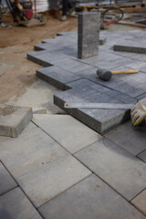 The Comprehensive Process for Installing Paving Stones Utilizing a Hammer and Protective Gloves