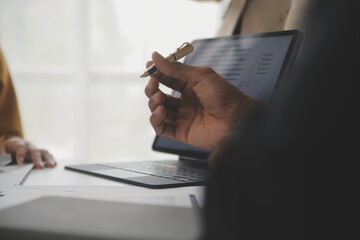 Close up of Business team analyzing income charts and graphs with modern laptop computer. Business...