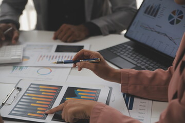 Close up of Business team analyzing income charts and graphs with modern laptop computer. Business...