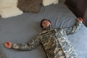 Young arab man wearing camouflage army uniform relaxing and stretching, arms and hands behind head and neck smiling happy.
