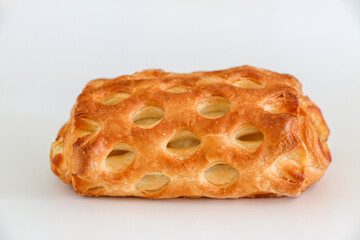 Close up of golden brown crusty pasty pie against white background