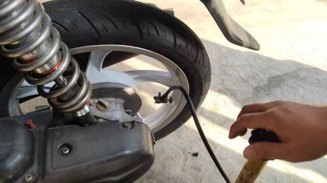 Illustration footage of pumping up a motorcycle tire