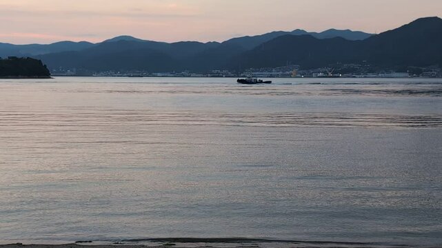 sunset on  Seto Inland sea with boat

