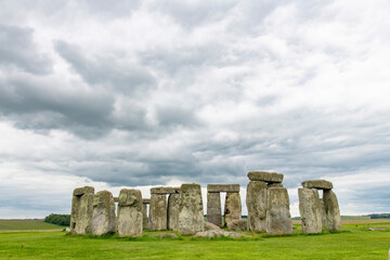 Naklejka premium Stonehenge prehistoric structure on Salisbury Plain, Wiltshire, England consisting of outer ring of vertical sarsen standing stones and inside ring of smaller bluestones against dramatic dark clouds