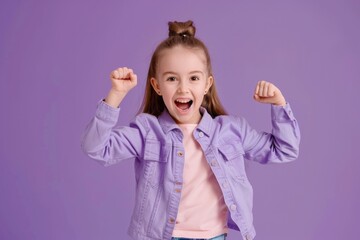 A young child expressing joy and excitement with her arms raised high