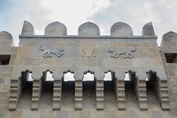 The bas-relief on the tower of ancient fortifications is a medieval symbol of the city of Baku, Azerbaijan. emblems of old city of Baku. Lion figures on Baku fortress .