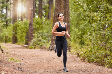 Fitness, smile and portrait of happy woman for cardio, exercise and running or outdoor marathon training. Girl, athlete and workout for health, wellness and forest trail for fresh air in park